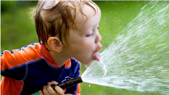 What to Know About Dehydration and How to Avoid It @2x - Picture of boy with Hose