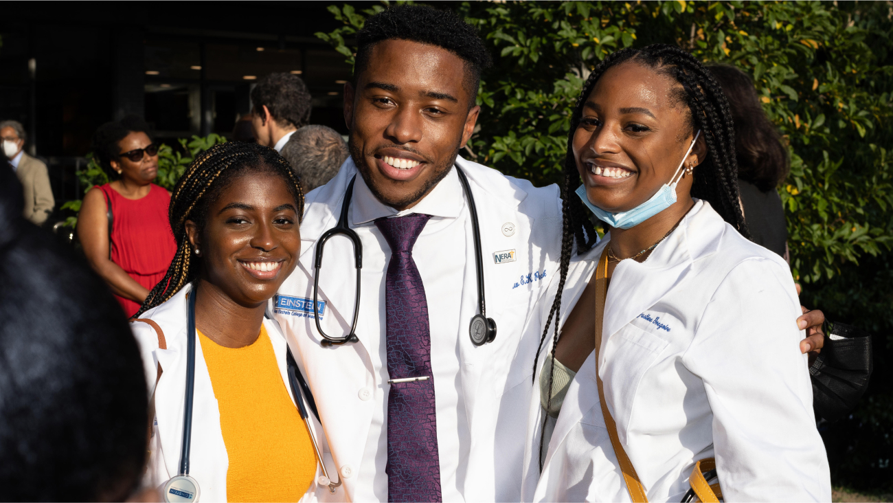 Three doctors smiling toward the camera.