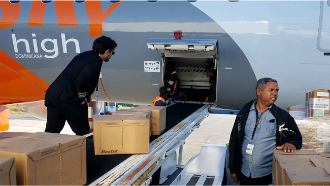 The crew loads supplies onto the conveyor.