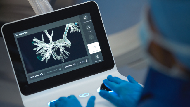 A doctor views a lung scan on a screen.