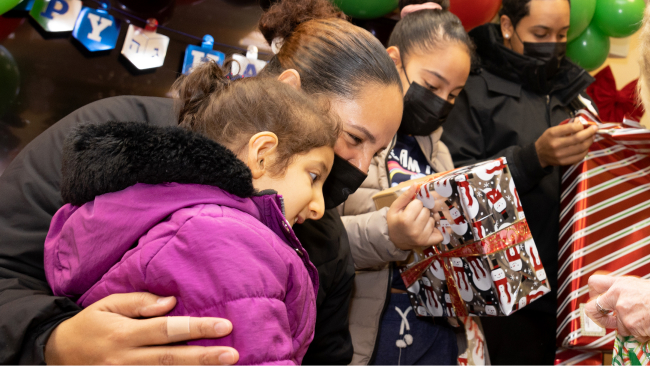 Kids open presents from Kisses for Kyla