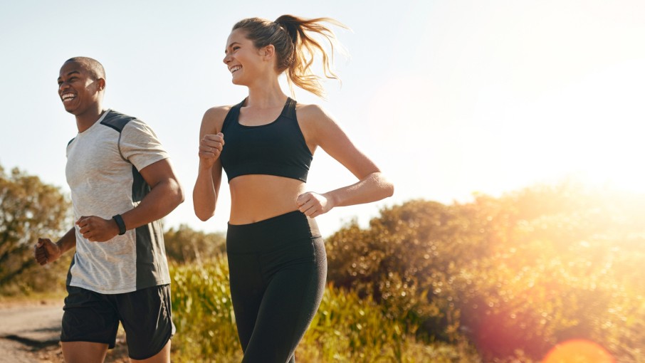 Two joggers running at sunrise.