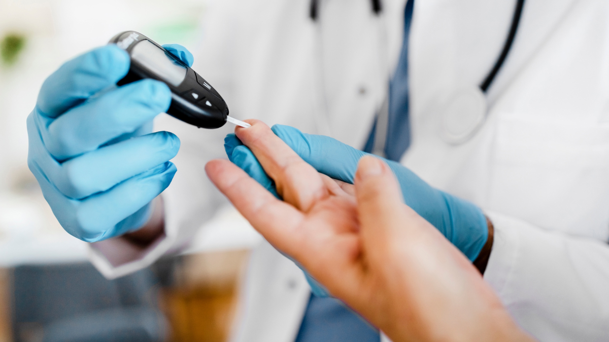 A technician takes a blood sample to test for diabetes.