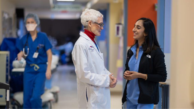 Deborah Makin, RN, MSN, CPEN and Aida Thomas, RN, MSN, BMTCN talking in the hall.