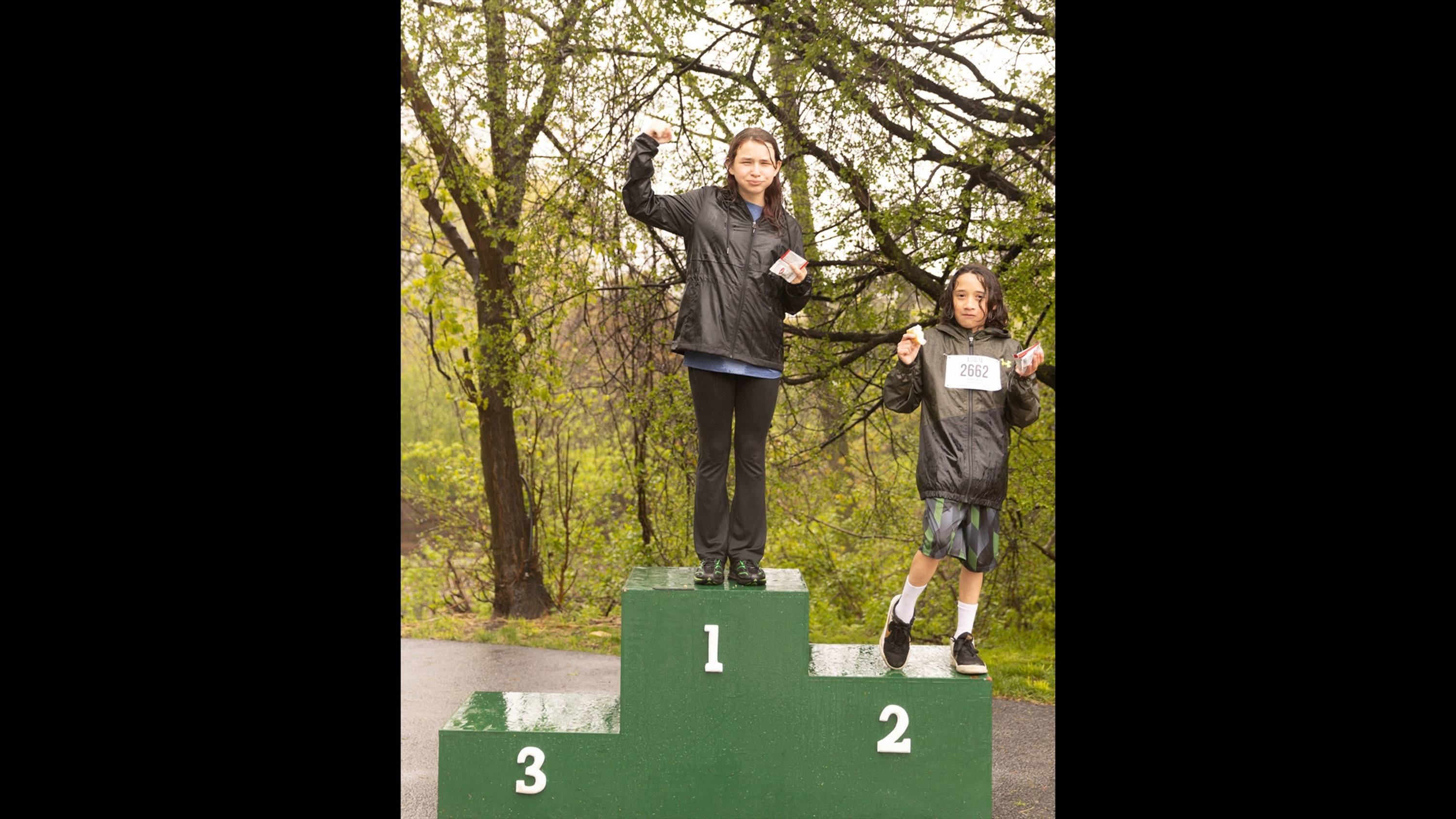 Young runners enjoy their awards at the award podium.