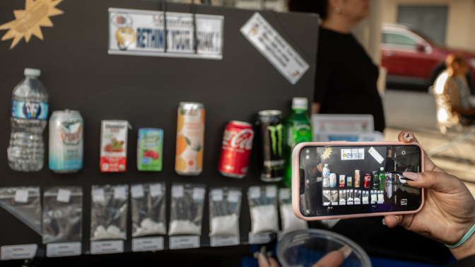 A board with sugar content information of various drinks from 'Rethink Your Drink', an informational program.