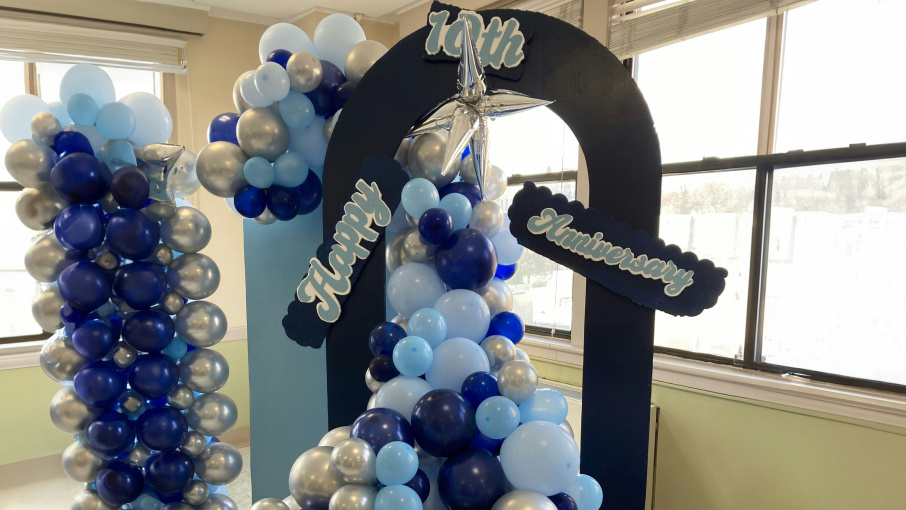A cheerful balloon arch done in navy, light blue and silver.