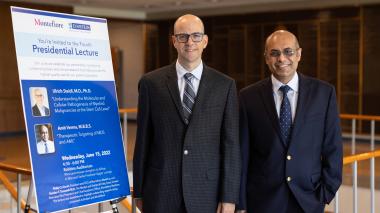 Two doctors standing next to sign