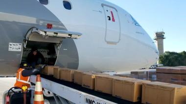 A jet being loaded with supplies via conveyor belt. 