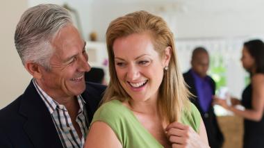 A man and a woman dancing and laughing.