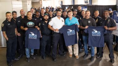 Yankees staff hold up t-shirts from the event.